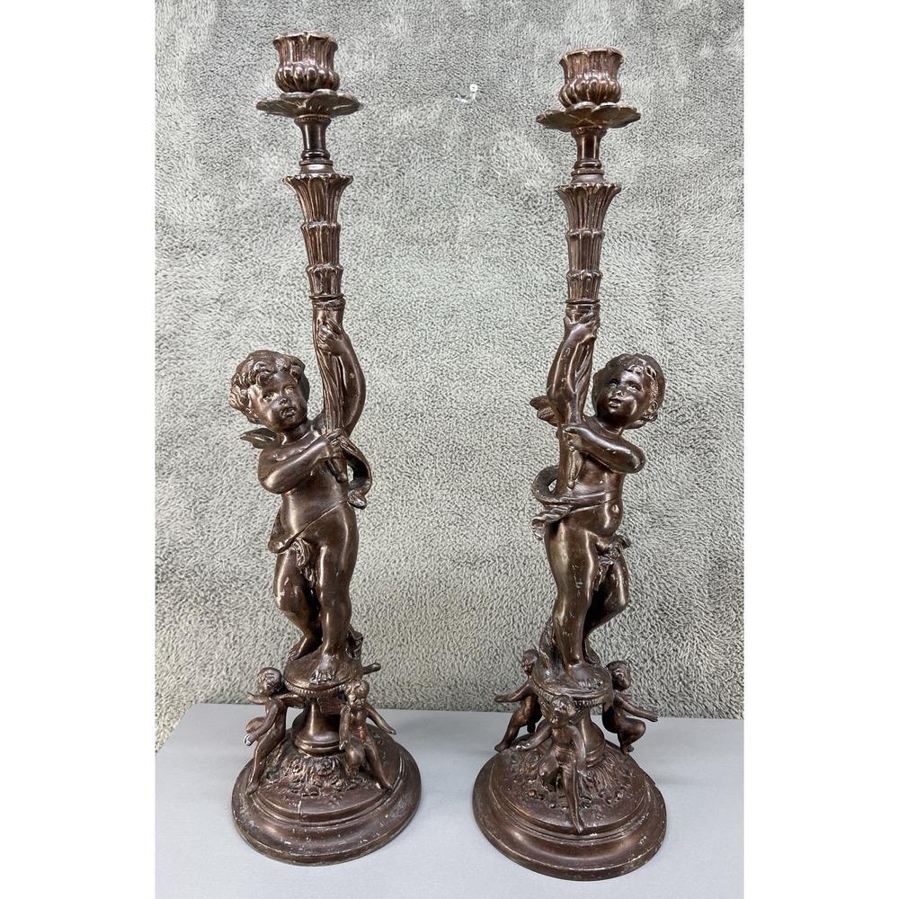 antique French Rococo-style candelabras featuring cherub figures.